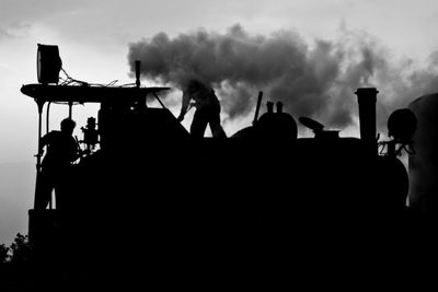 Silhouette people standing against sky