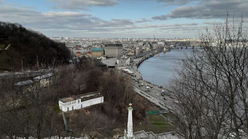 High angle view of river by city against sky