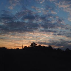 Silhouette landscape against scenic sky