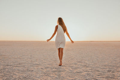 Full length of woman walking at beach