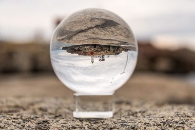 Close-up of water on beach against sky