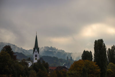 Panoramic view of trees and buildings against sky