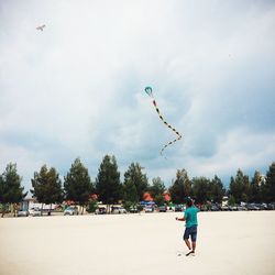 Person flying kite in sky
