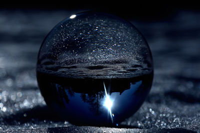 Close-up of crystal ball on metal