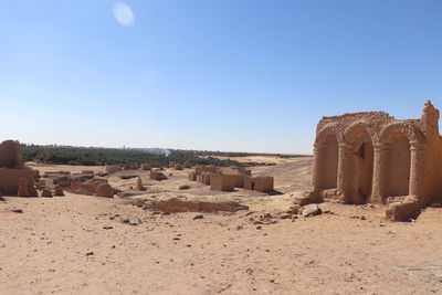 Panoramic view of desert against clear blue sky