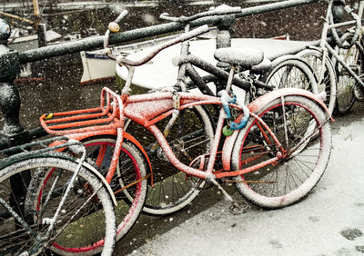 Bicycle parked on snow covered street during winter