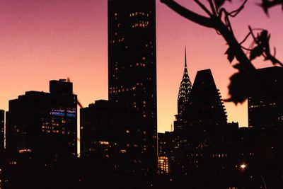 Low angle view of illuminated buildings against sky at dusk