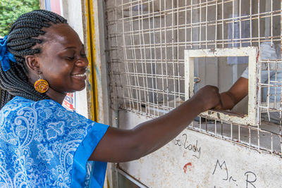 Africa ghana woman pays for her purchase with distance in a small fishing village shama