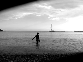 Silhouette people on boat in calm sea