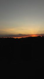 Silhouette landscape against sky during sunset