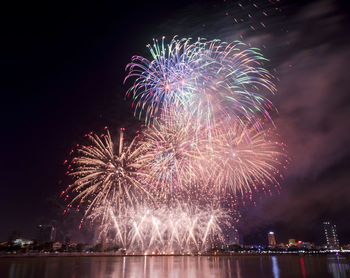 Low angle view of firework display at night