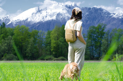 Rear view of woman standing against mountain