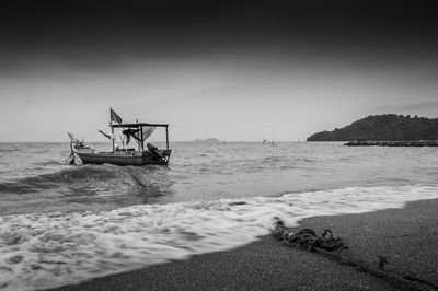 Boat moored near beach