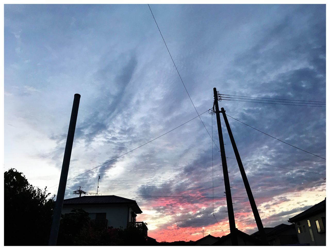 sky, cloud - sky, low angle view, silhouette, built structure, cable, no people, outdoors, building exterior, architecture, sunset, day, technology, tree, electricity pylon, nature, vapor trail