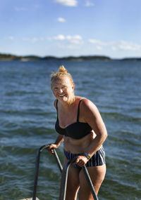 Smiling woman standing in bikini