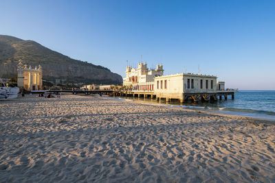 Beach view in sunset of alle terazze building mondello in palermo, sicily, italy.