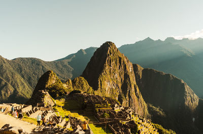 World heritage site machu picchu in peru at sunrise with sunrays on the mountain