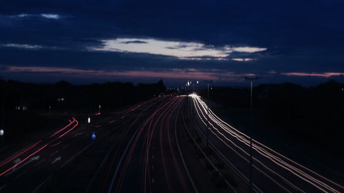 High angle view of light trails on highway at night