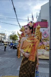 Woman standing on street in city