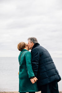 View from behind of an older couple kissing