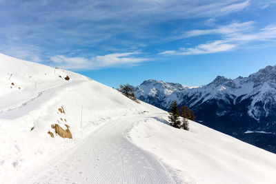 Scenic view of snow covered mountains against sky