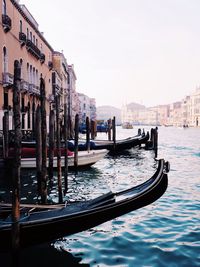 Boats in canal along buildings