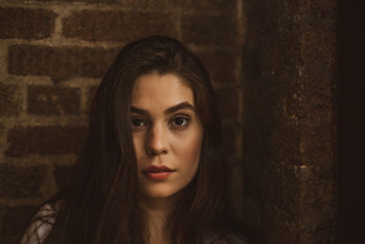 Portrait of woman against wall