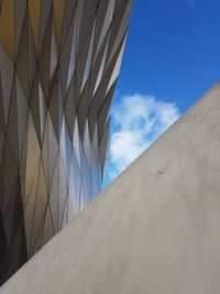 Low angle view of modern building against blue sky