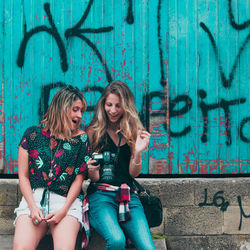 Young couple sitting on wall