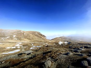 Scenic view of snowcapped mountains against clear blue sky