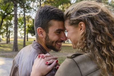 Happy young couple spending leisure time in public park