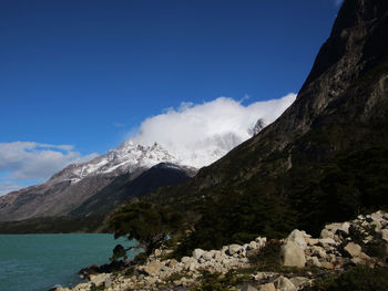 Scenic view of mountains against blue sky