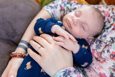 Midsection of mother with baby at home