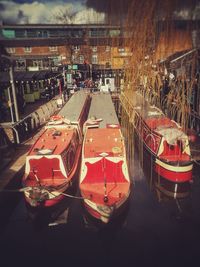 Close-up of boats moored in row