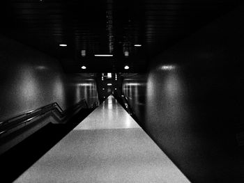 Illuminated underground walkway at night