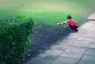 Rear view of boy on footpath