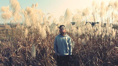 Man standing on field against sky