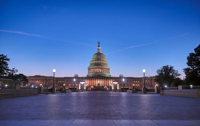 View of illuminated building against blue sky