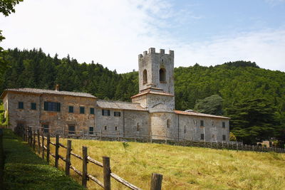 Built structure on field against sky