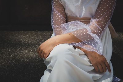 Close-up of bride sitting outdoors