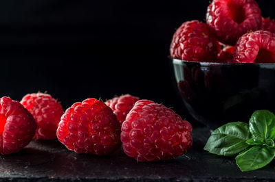 Close-up of strawberries in bowl against black background