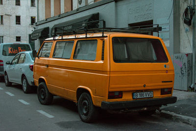 Car on street against buildings in city