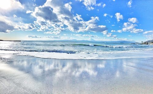 Scenic view of sea against cloudy sky