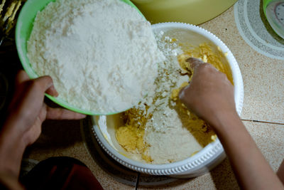 Midsection of woman preparing food in bowl