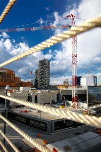 Construction site against cloudy sky