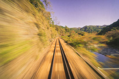 Blurred motion of railroad tracks against sky