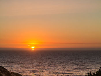 Scenic view of sea against romantic sky at sunset