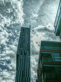 Low angle view of building against cloudy sky