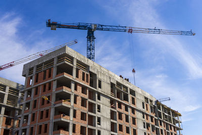 Construction site with cranes on sky background