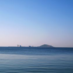 Scenic view of sea against clear blue sky